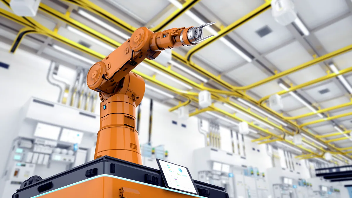 Un brazo robotico industrial en movimiento dentro de una fabrica moderna.