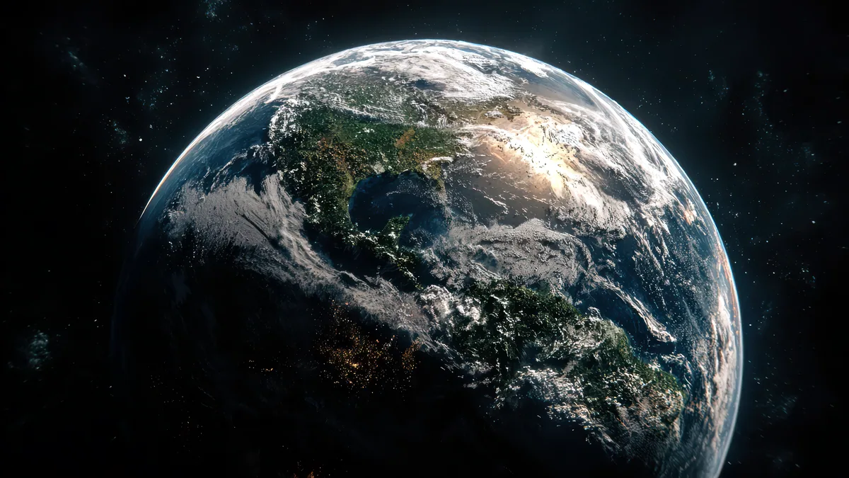 El planeta Tierra visto desde el espacio con las nubes blancas sobre los ocianos.